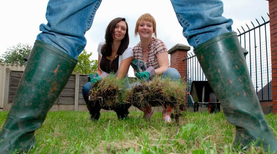 girls installing grass